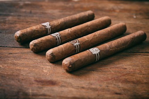 Cuban cigars on wooden background, copy space