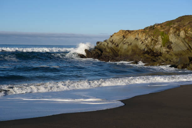 istock Waving sea near cliff and shore 1033045130