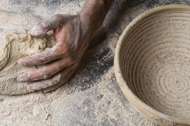 istock Male hands kneading dough on sprinkled 1033053514