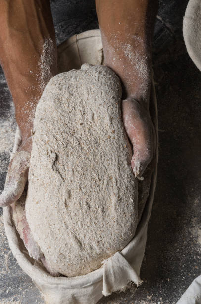 istock Male hands kneading dough on sprinkled 1033053582