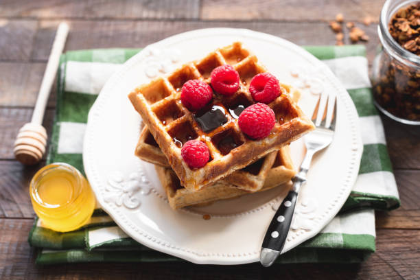 istock Belgian waffles with raspberries and honey 1033058426