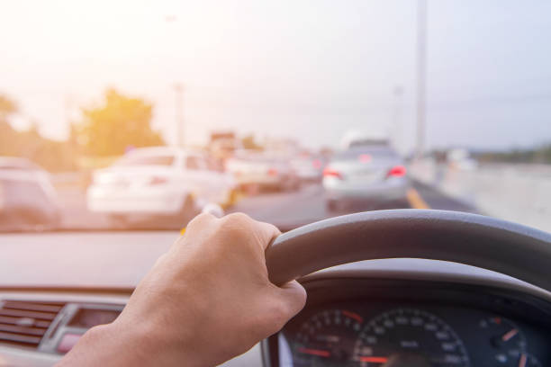 istock Close up Hands of a driver on road 1033061106