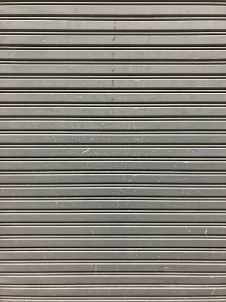 istock Gray Rustic store retail metal gate wall closed. 1033063172