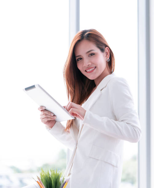 istock Smart Business woman using tablet by the window 1033063434
