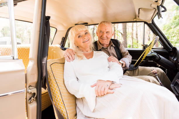 istock senior man hugging woman in beige car 1033072872