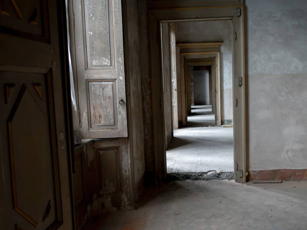 istock Ancient abandoned house with many rooms, windows, doors and long corridor 1033077992