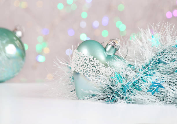 istock New Year or Christmas decorations on an abstract background, bokeh effect. White tinsel with turquoise stars. Can be used as wallpaper or greeting card. Selective focus, copy space. 1033078332