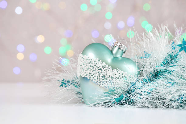 istock New Year or Christmas decorations on an abstract background, bokeh effect. White tinsel with turquoise stars. Can be used as wallpaper or greeting card. Selective focus, copy space. 1033078350