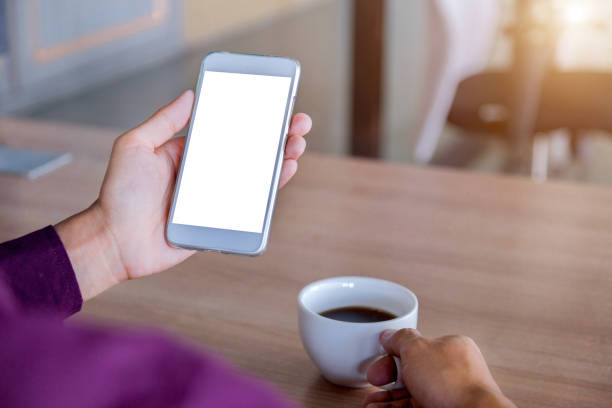 istock Mockup image of man's hands holding white mobile phone with blank screen technology 1033084148
