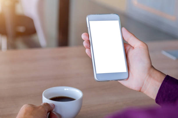 istock Mockup image of man's hands holding white mobile phone with blank screen technology 1033084236