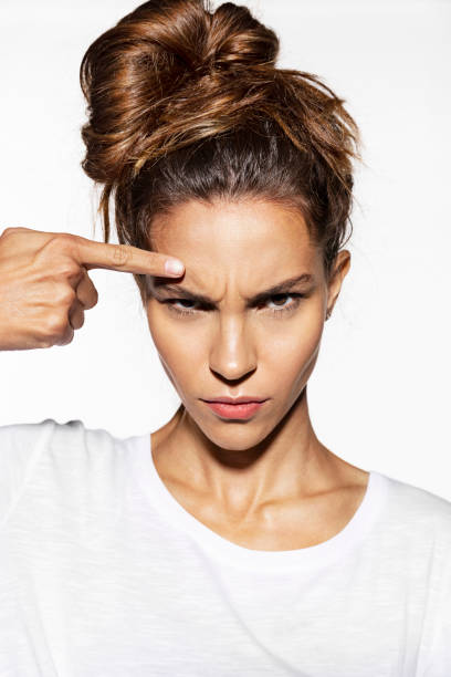 Beautiful young woman finds wrinkles on forehead