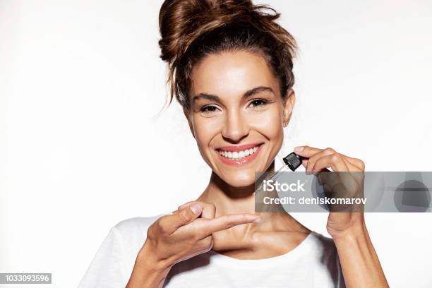 Young Woman Holding Face Oil Stock Photo - Download Image Now - Essential Oil, Human Face, Beauty