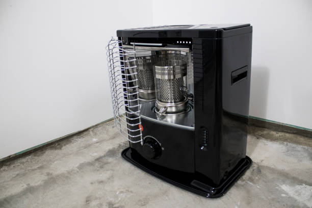 black kerosene heater in a white background composition - kerosene imagens e fotografias de stock