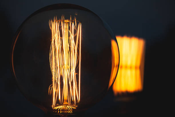 istock Retro stylized large tungsten lamp in dark 1033098354