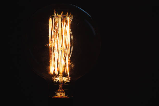 istock Vintage stylized tungsten lamp glowing at night 1033098356