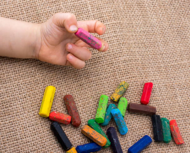 istock Used  color crayons and a toddlers hand 1033101580