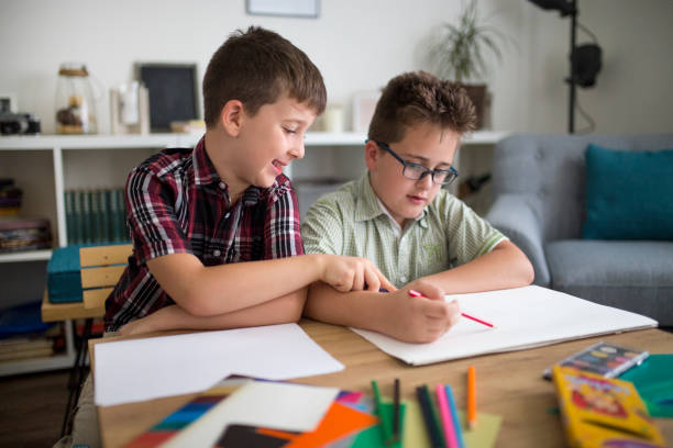 istock Little brothers enjoying drawing together 1033102158