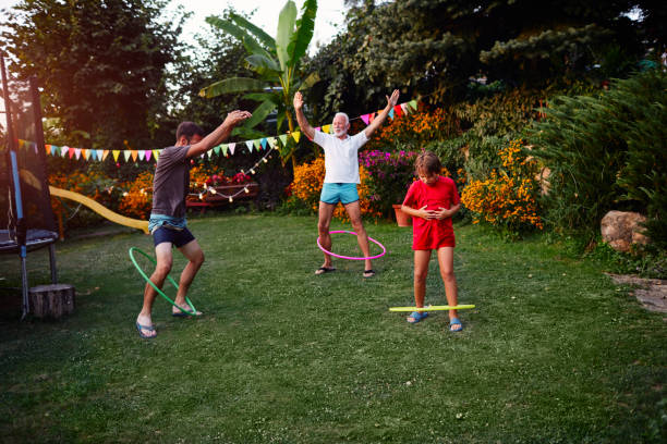 istock Multi generation family hula hooping in back yard 1033102164