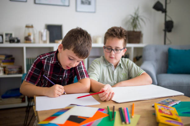 istock Little brothers enjoying drawing together 1033102212