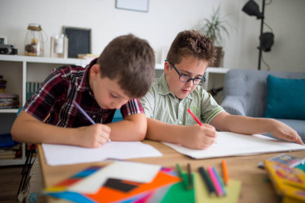 istock Little boys drawing together 1033102260