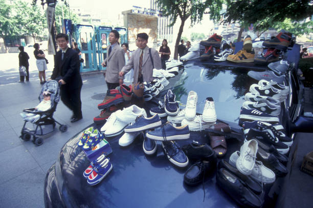 a shoe shop at a market in the city of Seoul in South Korea in EastAasia.  Southkorea, Seoul, May, 2006