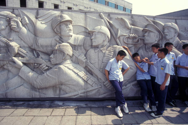children at a monument of the Korean War Memorial in the city of Seoul in South Korea in EastAasia.  Southkorea, Seoul, May, 2006