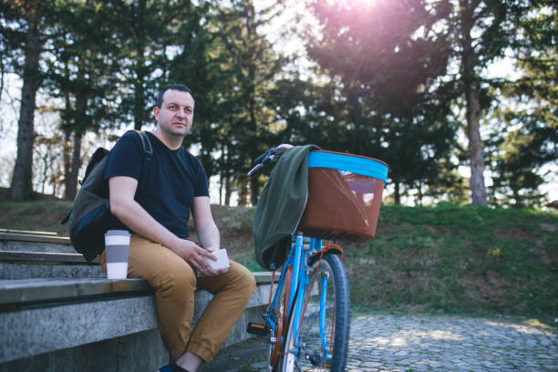 istock Young man with bicycle relaxing in park 1033122942