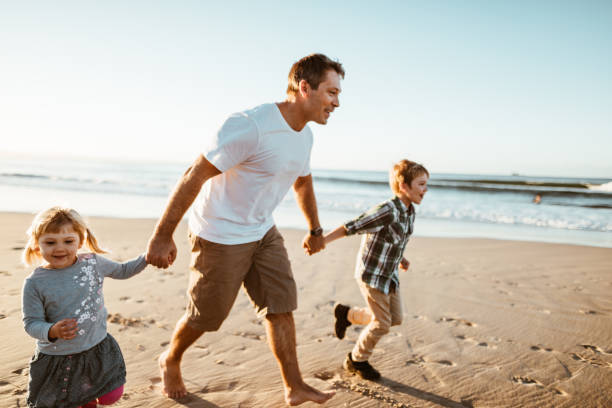 istock happiness father running on the beach with kids 1033135122