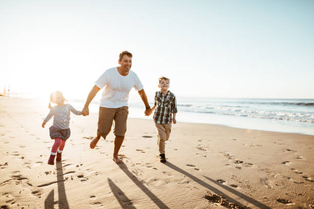 istock happiness father running on the beach with kids 1033135196
