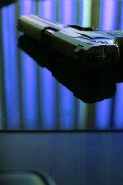istock Automatic pistol handgun in artistic light effect moody atmospheric photo closeup 1033141748