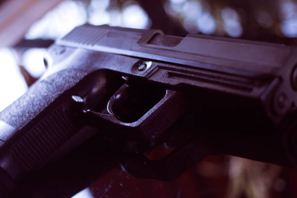istock Automatic pistol handgun in artistic light effect moody atmospheric photo closeup 1033141768