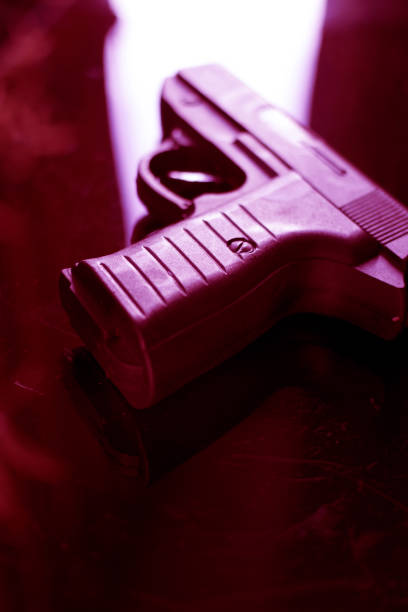 istock Automatic pistol handgun in artistic light effect moody atmospheric photo closeup 1033141910