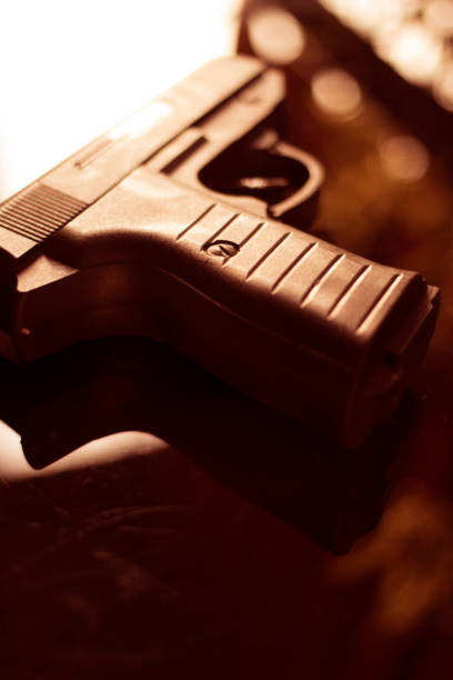 istock Automatic pistol handgun in artistic light effect moody atmospheric photo closeup 1033141924
