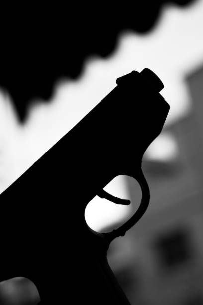 istock Automatic pistol handgun in artistic light effect moody atmospheric photo closeup 1033142000
