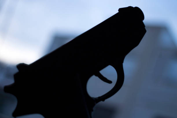 istock Automatic pistol handgun in artistic light effect moody atmospheric photo closeup 1033142114
