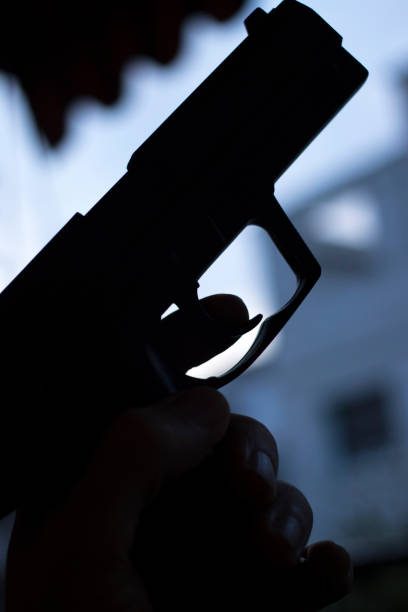 istock Automatic pistol handgun in artistic light effect moody atmospheric photo closeup 1033142276