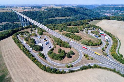 Aerial view of highway bridge with trucks and cars, truck stop and rest area, Baden Wurttemberg, Germany