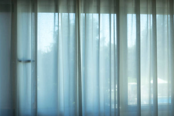 istock Hotel bedroom net curtains window with soft dalylight light. 1033153094