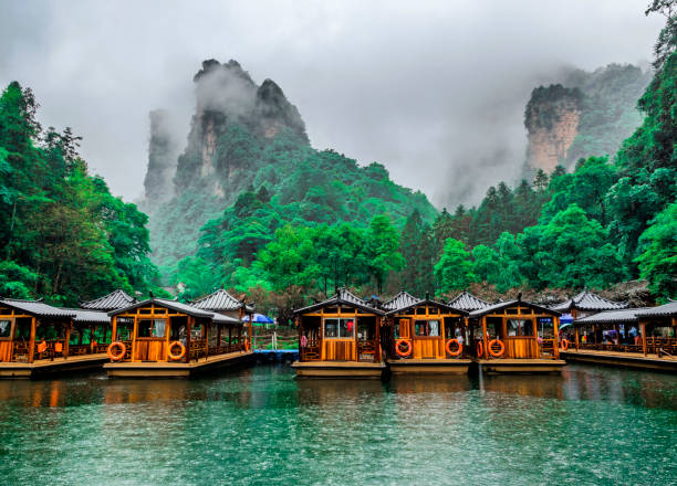 Baofeng Lake Boat Trip in a rainy day with clouds and mist at Wulingyuan, Zhangjiajie National Forest Park, Hunan Province, China, Asia stock photo