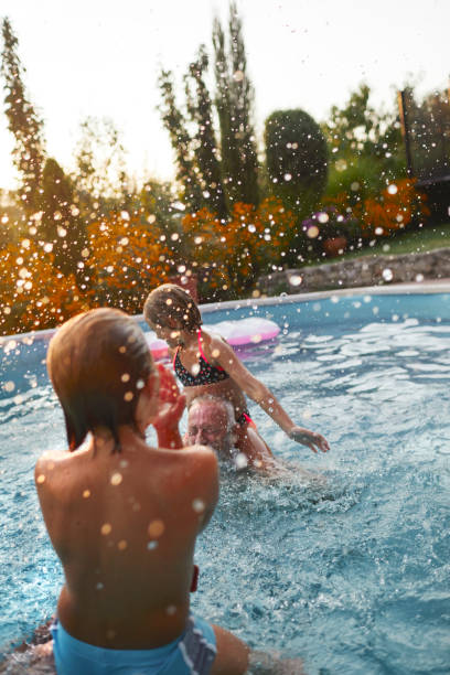 istock Multi generation family having fun on the pool 1033157106