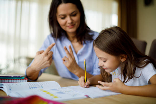 Mother helping daughter with homework Mother helping daughter with homework math homework stock pictures, royalty-free photos & images