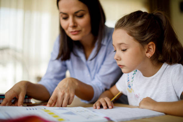 istock Mother helping daughter with homework 1033164230