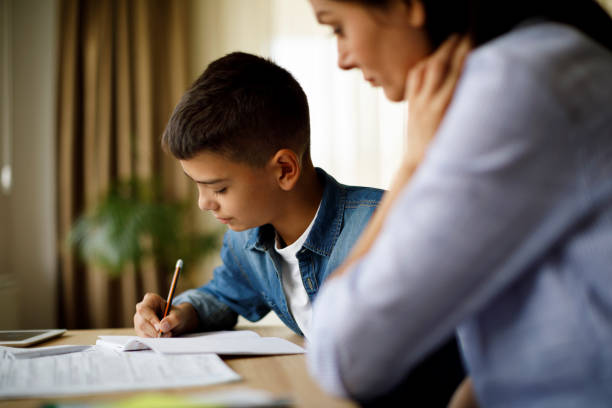 istock Mother helping her son with homework 1033164496