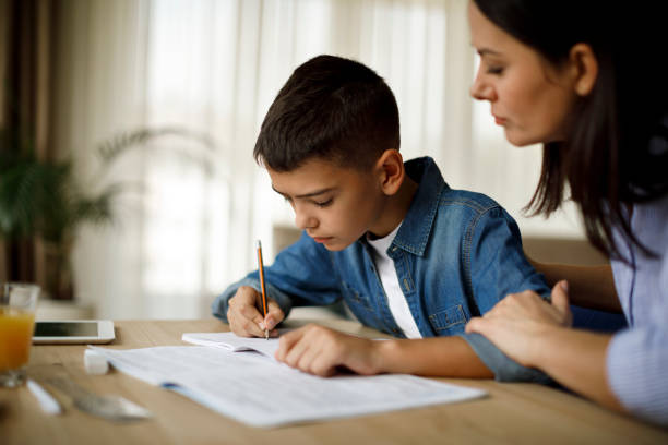 istock Mother helping her son with homework 1033164572