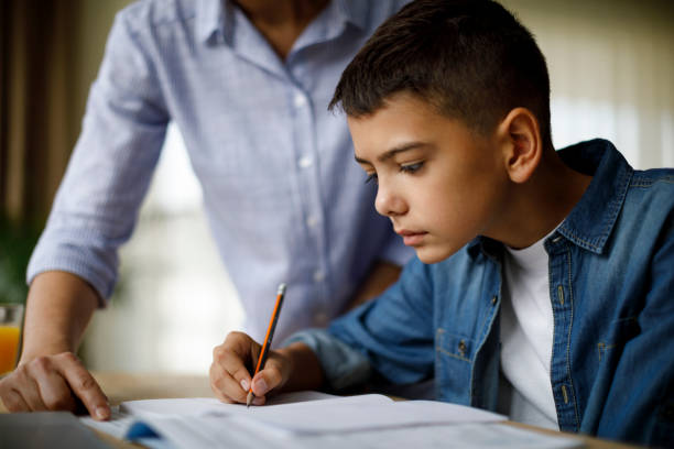 istock Mother helping her son with homework 1033164738