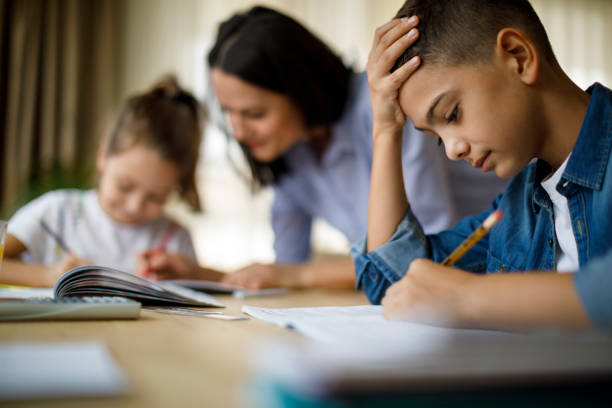istock Mother helping her kids with homework 1033164774