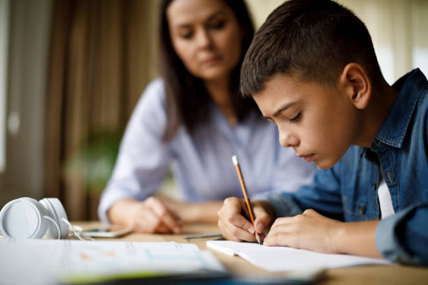 istock Mother helping her son with homework 1033164890