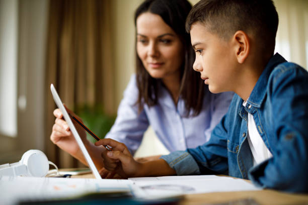 istock Mother helping teenager with homework 1033164922