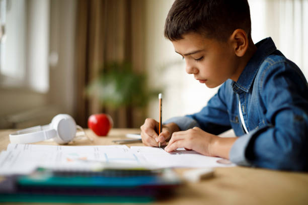 istock Teenage boy doing homework 1033165004