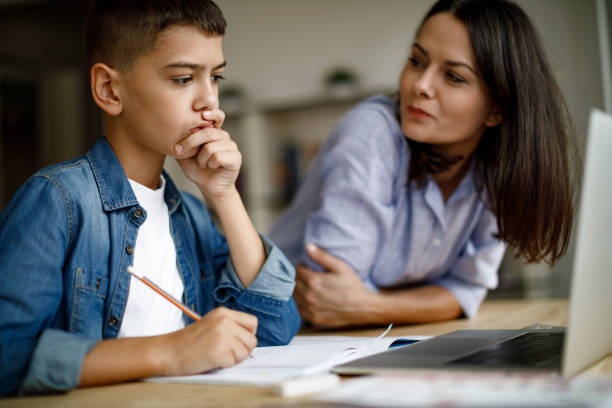 istock Mother helping teenager with homework 1033165036